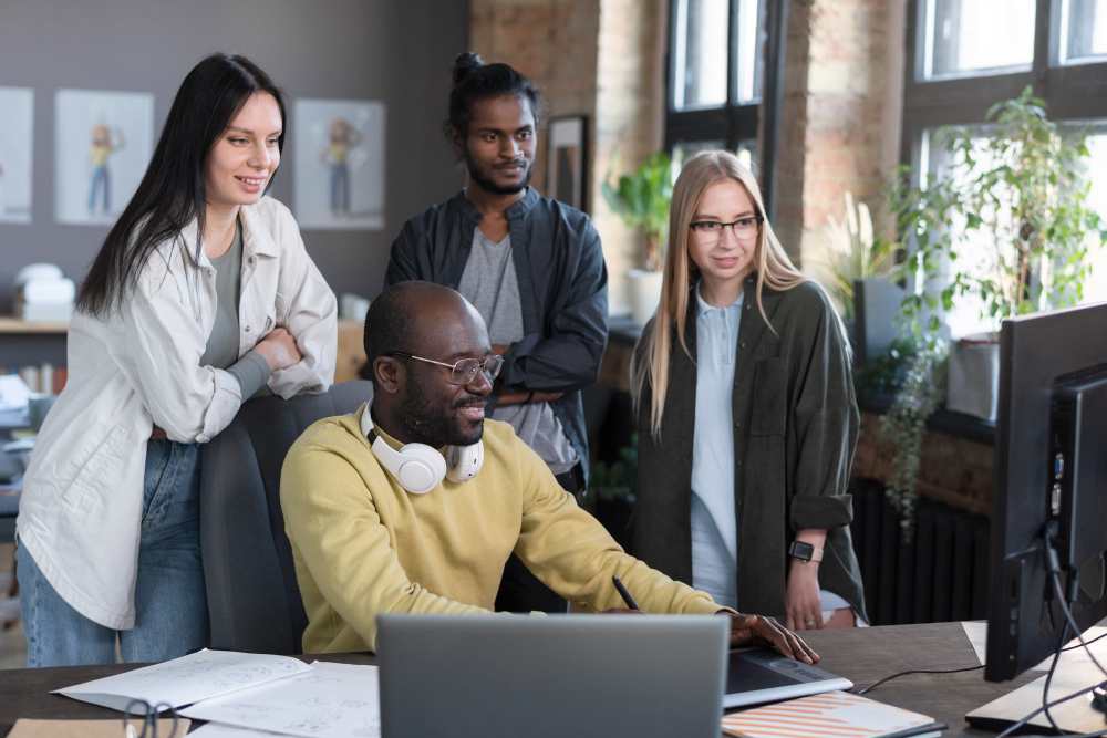 High school students collaborating around a table during an IT training session